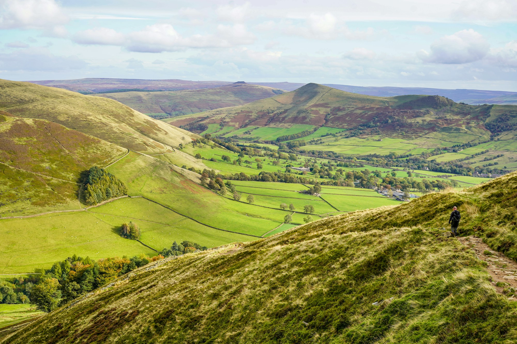 A walker on a green hillside above the Holme Valley, home of a West Yorkshire web designer and developer